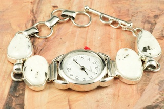4 Beautiful White Buffalo Turquoise Stones set in Sterling Silver Watch Bracelet. This Beautiful Stone is formed from the minerals Calcite and Iron. It is mined near Tonopah Nevada. This Beautiful Bracelet is a one of a kind Bracelet. The photo is of the jewelry you will be receiving. Created by Navajo Artist Tony Garcia. Signed by the artist.